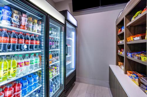 a refrigerator filled with lots of sodas and drinks at La Quinta Inn & Suites by Wyndham Valdosta in Valdosta