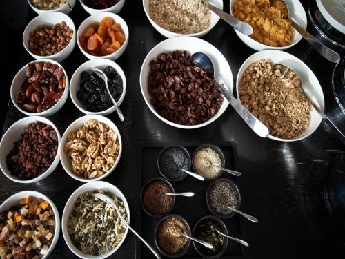 a table topped with bowls of different types of food at Victoria - Alpine Boutique Hotel & Fine Dining in Meiringen