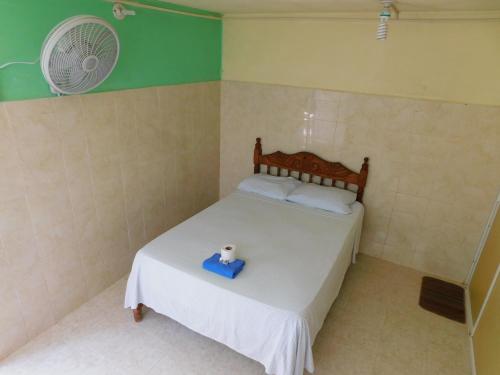 a small bedroom with a bed with a blue box on it at Centro Social Ecoturistico La Alberca in Jose Maria Morelos