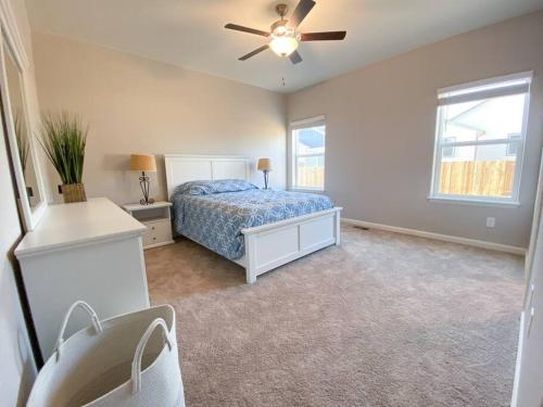 a bedroom with a bed and a ceiling fan at Spacious 3 bedroom home in Longmont