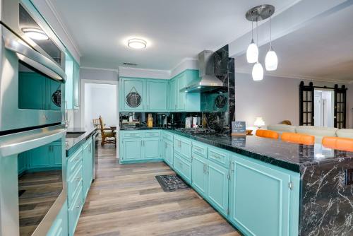 a kitchen with blue cabinets and black counter tops at Lakefront Retreat in Jefferson with Screened Porch! in Jefferson