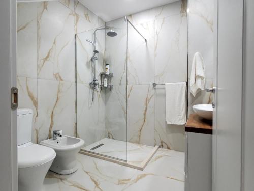 a bathroom with a shower and a toilet and a sink at Armando's house Durres in Durrës