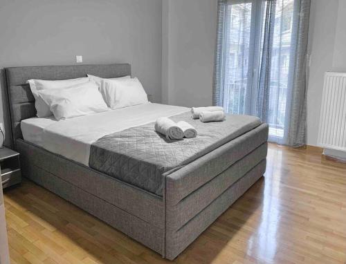 a bedroom with a bed with two towels on it at Athens heart city centre apartment in Athens
