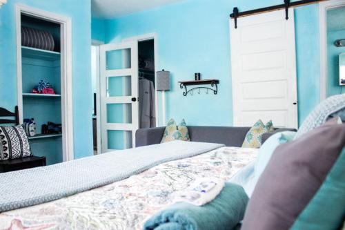 a bedroom with blue walls and a bed with pillows at Blue Bell Apartment Hotel in Fort Lauderdale
