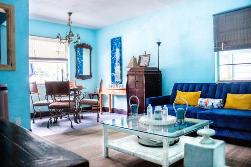 a living room with a blue couch and a table at Blue Bell Apartment Hotel in Fort Lauderdale
