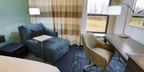 a hotel room with a desk and a chair at Hampton Inn & Suites Nashville-Airport in Nashville