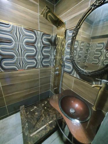 a bathroom with a sink and a mirror at جراند ماجيك سويت in Cairo