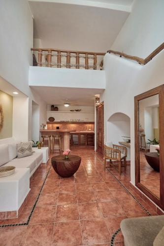 a living room with a couch and a table at La Villa Luz (sólo adultos) in Zihuatanejo