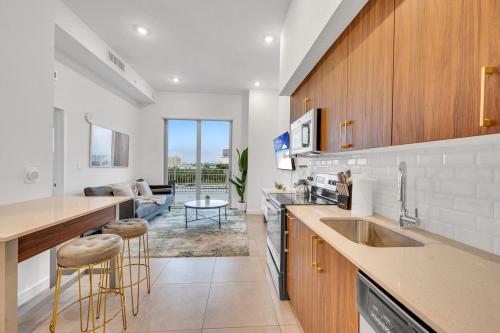 a kitchen with a sink and a living room at Modern Unit in Downtown Miami With Free Parking in Miami