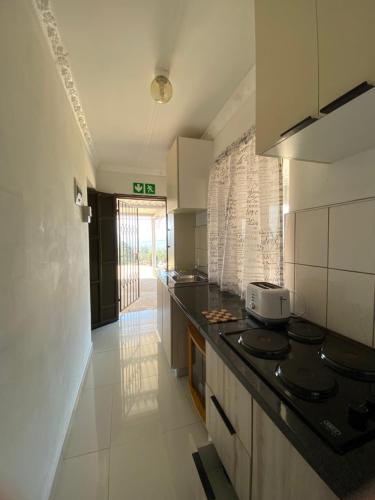 a kitchen with a stove and a counter top at 4 Centenary Road Ixopo in Ixopo