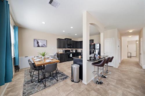 a kitchen and living room with a table and chairs at Near IAH Houston Home Yard BBQ Games Wi-Fi Pets in Houston
