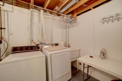 a white laundry room with a stove and a washer at Simple and Charming Idaho Retreat with Pellet Smoker in Idaho Falls