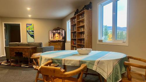a dining room with a table and chairs and a window at The Big Red Barn in Whitehorse