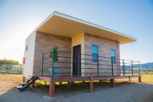 a small house with a porch and a bench at Ambar en el Valle in Ensenada
