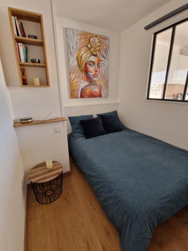 une chambre avec un lit et un tableau au mur dans l'établissement Très belle marina plein sud, au Grau-du-Roi