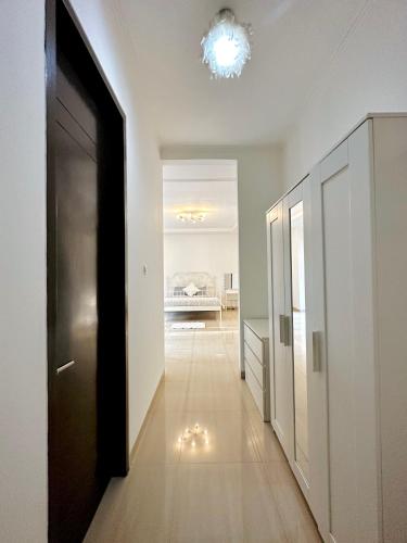 a hallway with a door leading to a living room at 4-Bedroom Home in South Jakarta Nuansa Swadarma Residence by Le Ciel Hospitality in Jakarta