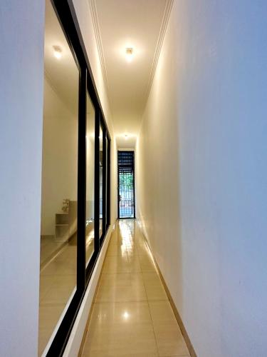 a hallway of a house with white walls and windows at 4-Bedroom Home in South Jakarta Nuansa Swadarma Residence by Le Ciel Hospitality in Jakarta