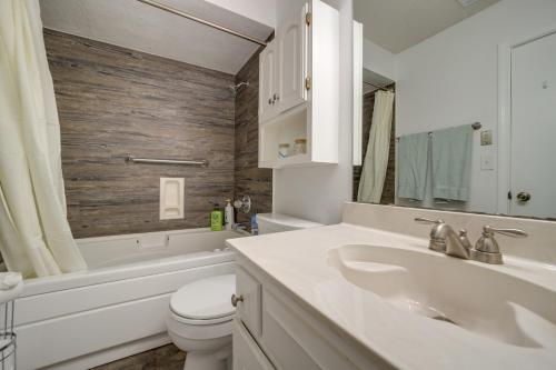 a bathroom with a sink and a toilet and a tub at Family-Friendly Broken Arrow Retreat with Yard! in Broken Arrow