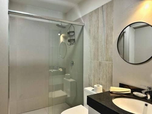 a bathroom with a shower and a sink and a mirror at Zona Exclusiva Céntrico 7 pers. Cochera in Arequipa