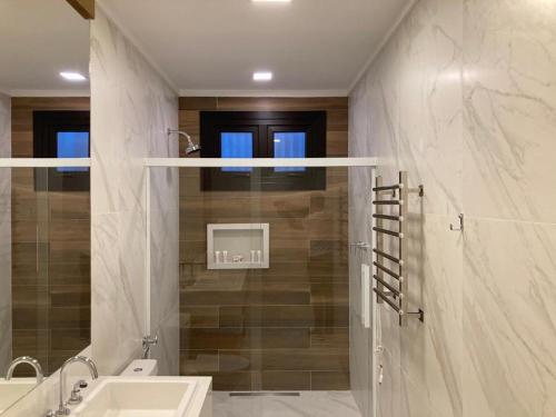 a bathroom with a sink and a shower at Austin Suites Gramado in Gramado