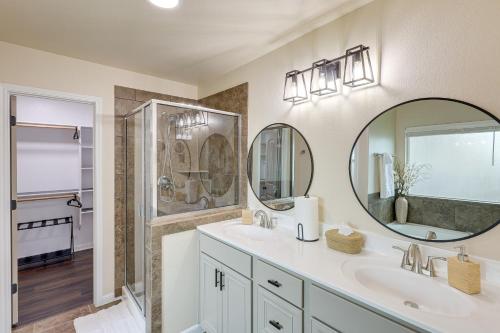 a bathroom with two sinks and a large mirror at Modern Killeen Vacation Rental with Private Patio! in Killeen
