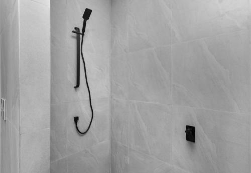 a shower with a shower head in a bathroom at Studio Varia in Rarotonga