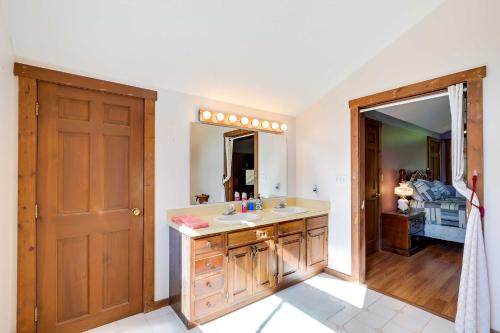 a bathroom with a sink and a mirror at Spacious Woodbury Home with Pool and Hot Tub! in Woodbury