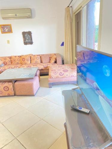 a living room with a couch and a remote control at فيلا للإيجار مارينا 7 الساحل الشمالي in El Alamein