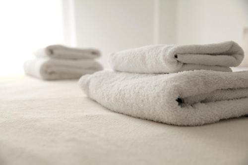 a pile of towels sitting on top of a bed at Citybreak Apartments 302 in Athens