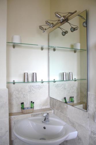 a bathroom with a sink and a mirror at Residenza Porta Guelfa in Bevagna