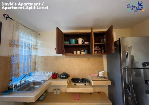 a small kitchen with a sink and a refrigerator at Casa de Yoli in Cozumel