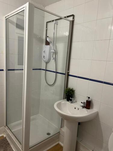 a bathroom with a shower and a sink at De Luxe Apartment in Leicester