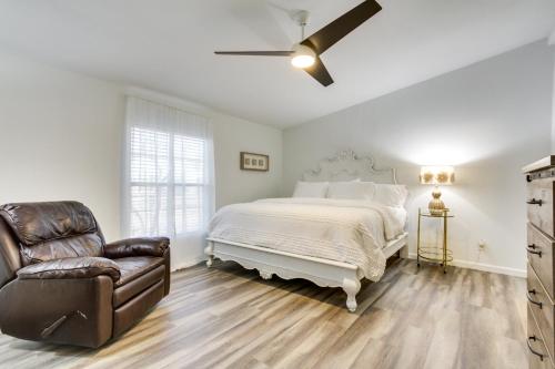 a bedroom with a bed and a chair and a ceiling fan at Phoenix Family Home Near Cave Creek and Hiking! in Phoenix