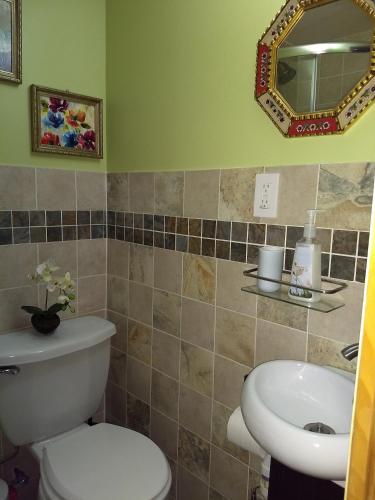 a bathroom with a toilet and a sink at Cozy studio at the heart of Jackson Heights in Queens