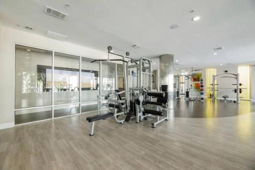 a gym with treadmills and machines in a room at Check me out! in Dallas