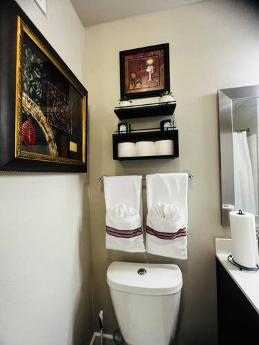 a bathroom with a toilet and a sink with towels at FIFA WORLD CUP! Close to Dallas Love Field Airport Downtown Dallas Medical District in Dallas