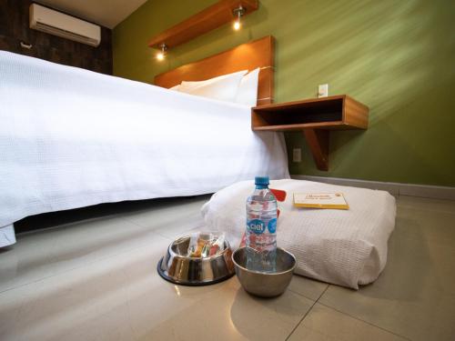 a bottle of water and a bowl of food in a room at Hotel Calafia in Mexicali