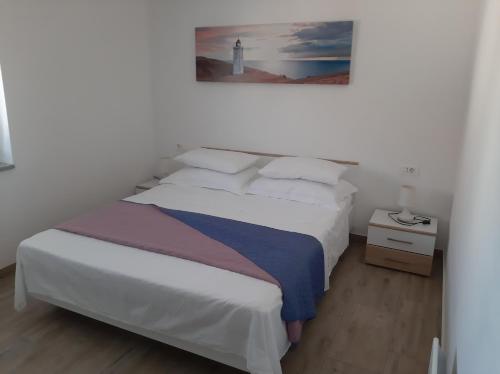 Postel nebo postele na pokoji v ubytování Apartman SILVANO