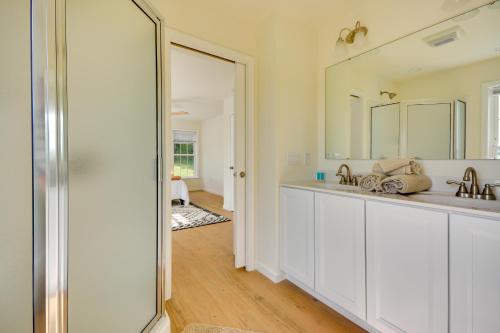 a bathroom with two sinks and a mirror at Timeless Hillsville Farmhouse Blue Ridge Parkway! in Ararat