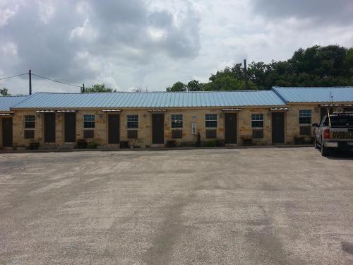 a large building with a parking lot in front of it at Star Inn in Karnes City