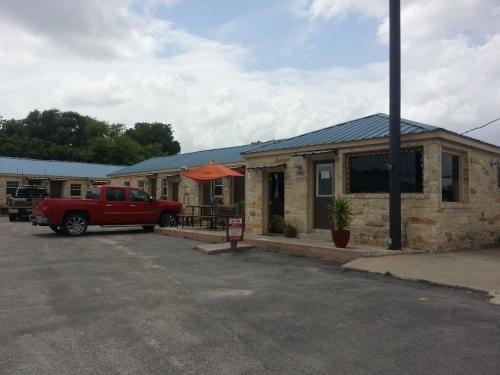 a red truck parked in front of a house at Star Inn in Karnes City