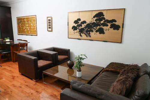 a living room with two couches and a table at Peaceful Zen Getaway in the City in Philadelphia