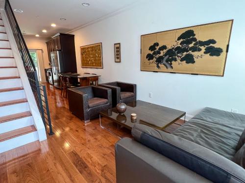 a living room with a couch and a table at Peaceful Zen Getaway in the City in Philadelphia