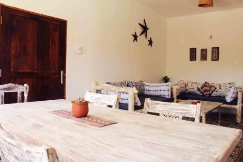 a living room with a table and chairs and a couch at Manasha Apartment 1 in Watamu