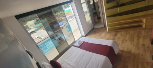 an overhead view of a room with a bed and a pool at Hotel Naisca 47 in Pasto