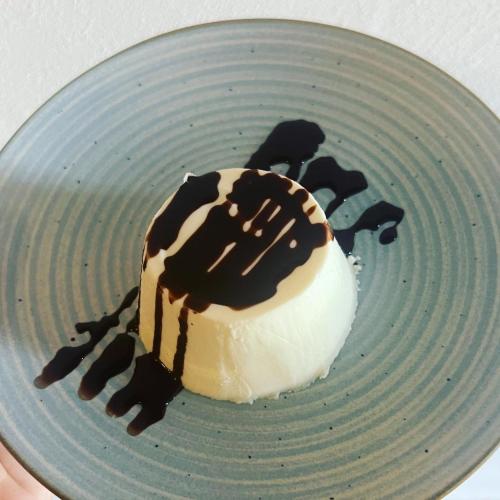 a dessert on a blue plate with chocolate on it at LOCANDA PODERE LE VIGNE in Radda in Chianti