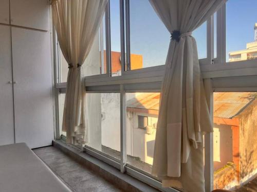 a large window with curtains in a room at Hermoso depto, a pasos de todo. in Corrientes