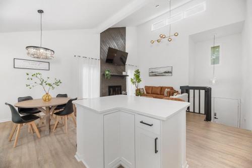 a white kitchen and dining room with a table at Beautiful 6 bed 3 bath home in quiet neighborhood in Wichita