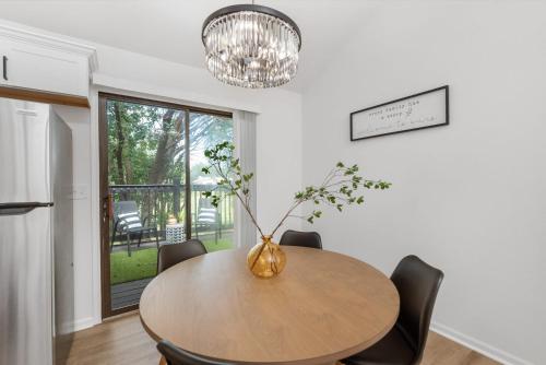 a dining room with a table and a vase with a plant at Beautiful 6 bed 3 bath home in quiet neighborhood in Wichita