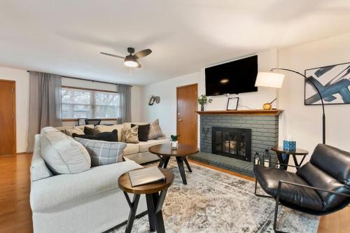 a living room with a couch and a fireplace at 3 Bed 2 Bath Home w 2 Car Garage & Fitness Room in Wichita